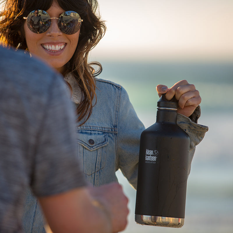 64oz-classic-with-loop-cap-b4 64oz_insulated_classic_black_beach_girl_hand_square.jpg