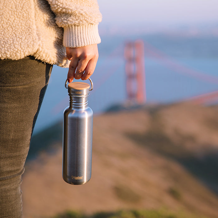 27oz-reflect-with-bamboo-cap-g6 K27SSLRF-BS-BAMBOO_reflect_bottle_bridge_lifestyle.jpg